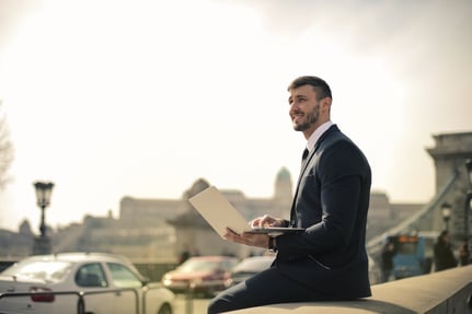 Man Wearing Black Suit While Using Laptop